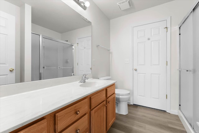 1719 Ambrose Terrace Dr, Swansea, IL 62226 - full bathroom with a stall shower, wood finished floors, vanity, and toilet