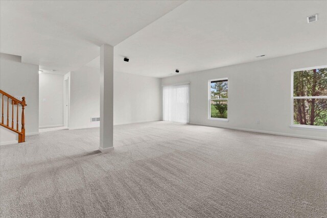 1719 Ambrose Terrace Dr, Swansea, IL 62226 - unfurnished living room with carpet, plenty of natural light, stairs, and baseboards