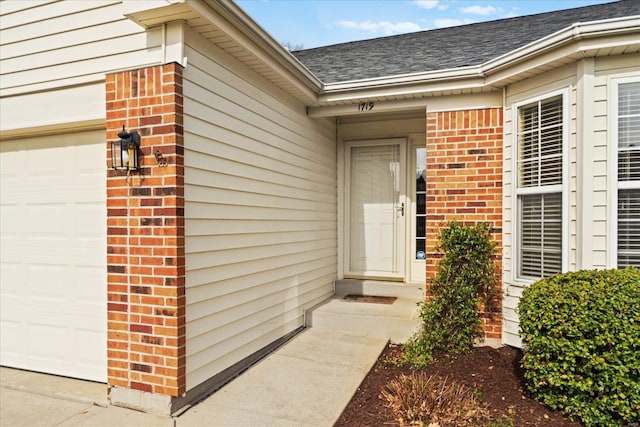1719 Ambrose Terrace Dr, Swansea, IL 62226 - doorway to property with brick siding, roof with shingles, and an attached garage