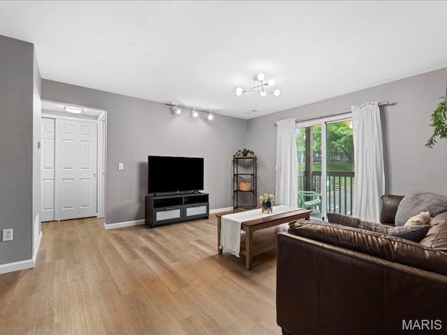 1015 Adworth Dr Unit F, Saint Louis, MO 63125 - living room with light wood finished floors and rail lighting