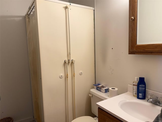 bathroom featuring toilet and vanity