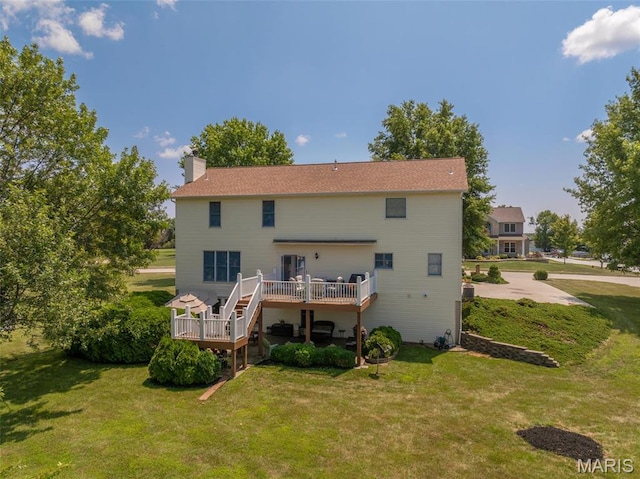 1005 Highland Estates Dr, Wentzville, MO 63385 - back of house featuring a wooden deck, a chimney, and a yard