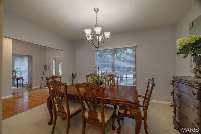 1005 Highland Estates Dr, Wentzville, MO 63385 - dining room with plenty of natural light, a chandelier, baseboards, and light carpet