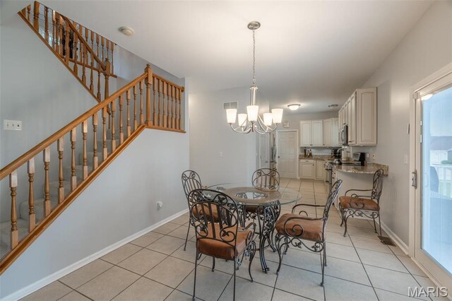 1005 Highland Estates Dr, Wentzville, MO 63385 - dining space with a chandelier, light tile patterned flooring, stairs, and baseboards
