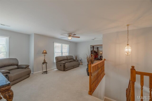1005 Highland Estates Dr, Wentzville, MO 63385 - carpeted living room featuring healthy amount of natural light, baseboards, and a ceiling fan