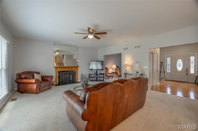 1005 Highland Estates Dr, Wentzville, MO 63385 - carpeted living room with a ceiling fan, plenty of natural light, and a fireplace