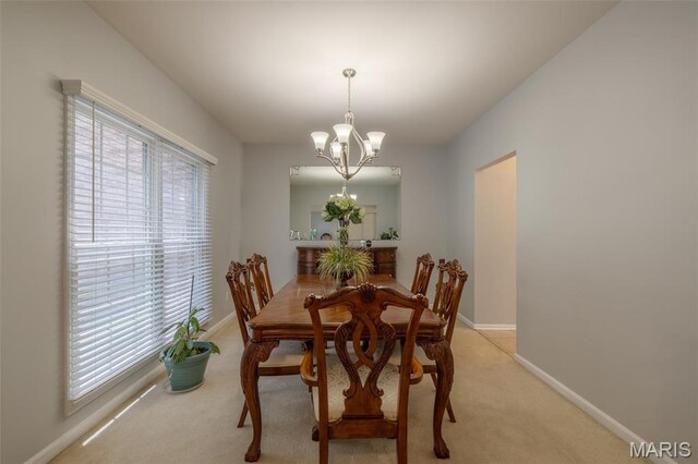 1005 Highland Estates Dr, Wentzville, MO 63385 - dining room with a chandelier, light colored carpet, and baseboards
