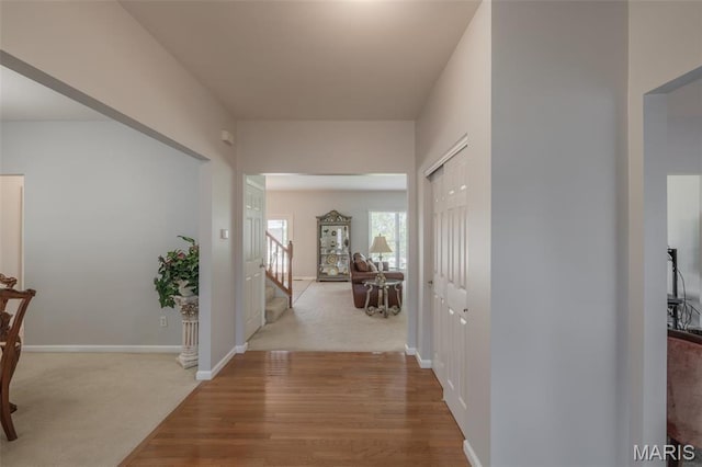 1005 Highland Estates Dr, Wentzville, MO 63385 - hall with stairs, wood finished floors, and baseboards