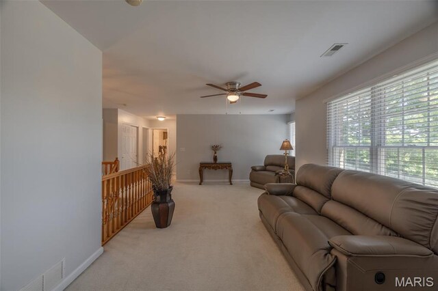 1005 Highland Estates Dr, Wentzville, MO 63385 - living area with light carpet, a ceiling fan, healthy amount of natural light, and baseboards