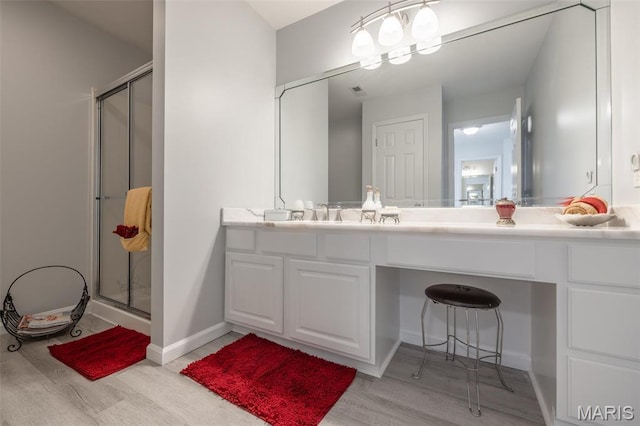 1005 Highland Estates Dr, Wentzville, MO 63385 - bathroom with wood finished floors, a stall shower, vanity, and baseboards