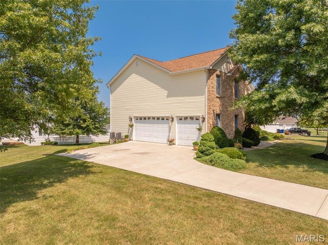 1005 Highland Estates Dr, Wentzville, MO 63385 - view of property exterior with a garage, a yard, driveway, and brick siding