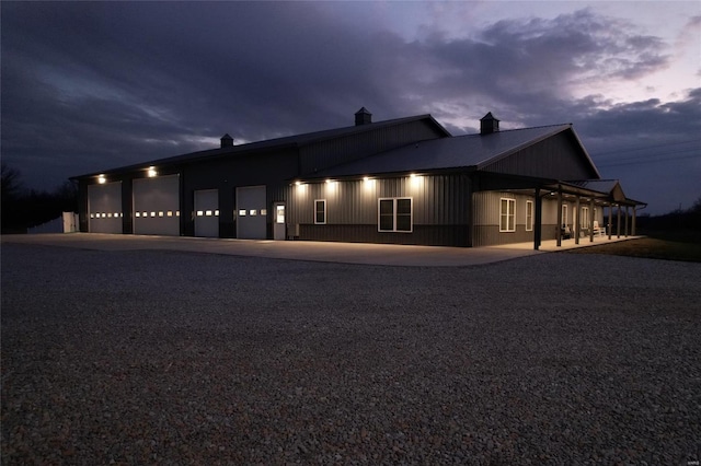 25371 Audrain Road 808, Mexico, MO 65265 - view of front facade with driveway, an attached garage, metal roof, and a chimney