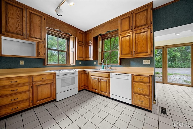 430 Cap Au Gris St, Troy, MO 63379 - kitchen with white appliances, a sink, light countertops, light tile patterned floors, and brown cabinets