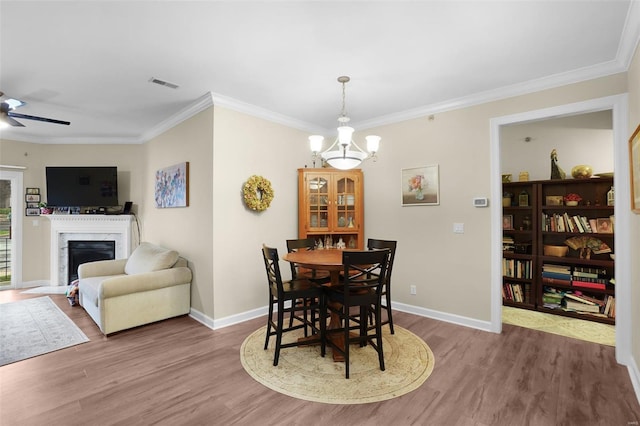 13115 Mill Crossing Ct Unit 106, Saint Louis, MO 63141 - dining area featuring wood finished floors, ornamental molding, baseboards, a high end fireplace, and a chandelier