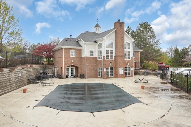 13115 Mill Crossing Ct Unit 106, Saint Louis, MO 63141 - rear view of house featuring a chimney, fence, a patio, brick siding, and french doors
