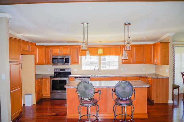 1077 Creech School Rd, Troy, MO 63379 - kitchen featuring stainless steel appliances, a kitchen island, dark wood-style floors, a sink, and ornamental molding
