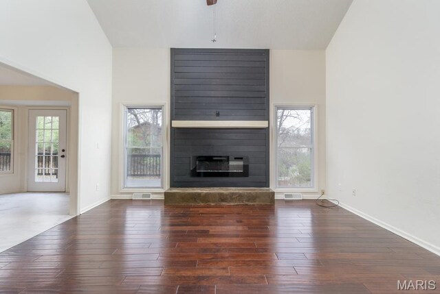 212 Tremont Dr, Waynesville, MO 65583 - unfurnished living room with a fireplace, wood finished floors, and baseboards