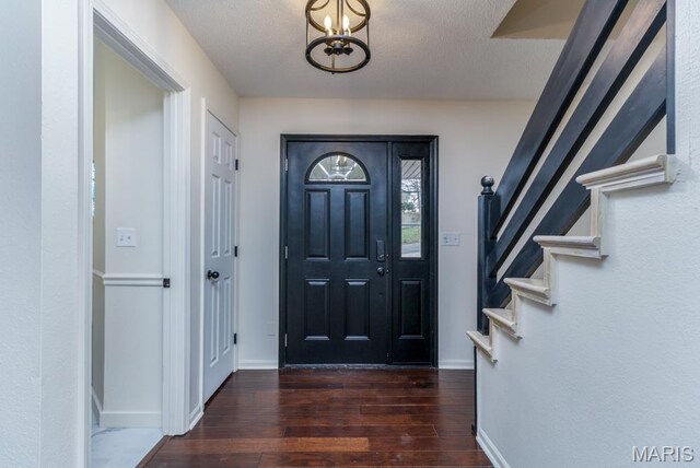 212 Tremont Dr, Waynesville, MO 65583 - foyer featuring hardwood / wood-style floors, baseboards, stairs, a chandelier, and a textured ceiling
