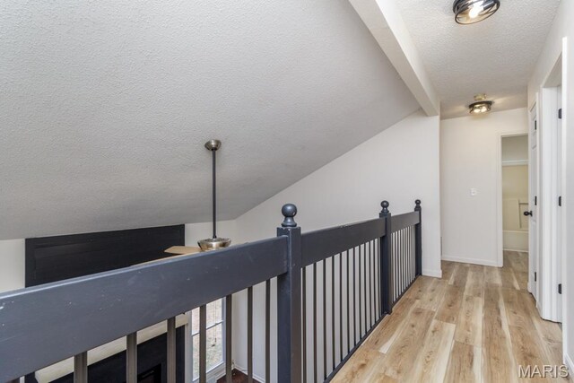 212 Tremont Dr, Waynesville, MO 65583 - hall with a textured ceiling, light wood-style floors, and vaulted ceiling