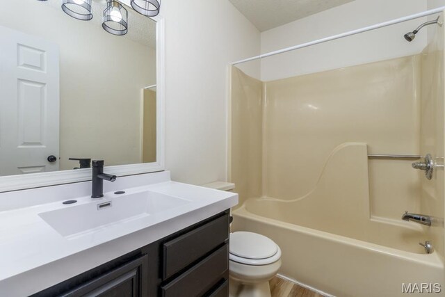 212 Tremont Dr, Waynesville, MO 65583 - full bath featuring vanity, shower / bath combination, toilet, a textured ceiling, and wood finished floors