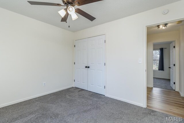 212 Tremont Dr, Waynesville, MO 65583 - unfurnished bedroom featuring carpet flooring, baseboards, a closet, and a ceiling fan