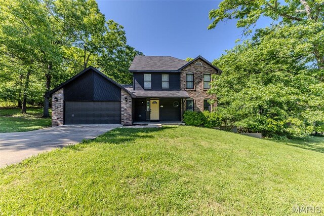 212 Tremont Dr, Waynesville, MO 65583 - view of front of property featuring concrete driveway, a front lawn, and a garage