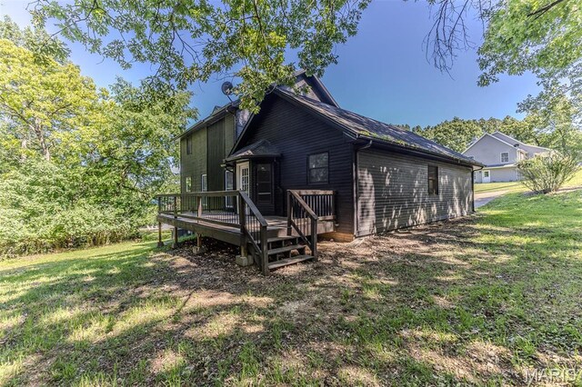 212 Tremont Dr, Waynesville, MO 65583 - rear view of house with a deck and a lawn