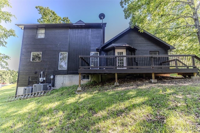 212 Tremont Dr, Waynesville, MO 65583 - back of property featuring a wooden deck, a lawn, and central air condition unit
