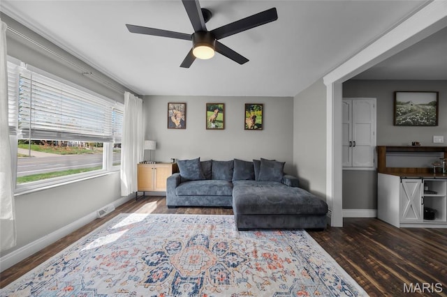 9748 Mackenzie Rd, Saint Louis, MO 63123 - living area with baseboards, a ceiling fan, and dark wood-style flooring