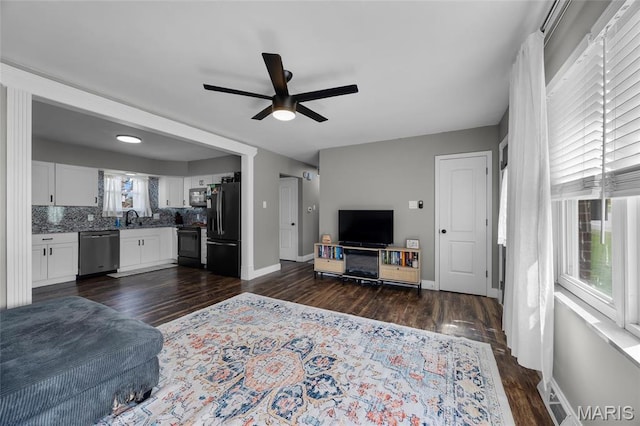 9748 Mackenzie Rd, Saint Louis, MO 63123 - living room with ceiling fan, dark wood finished floors, and baseboards