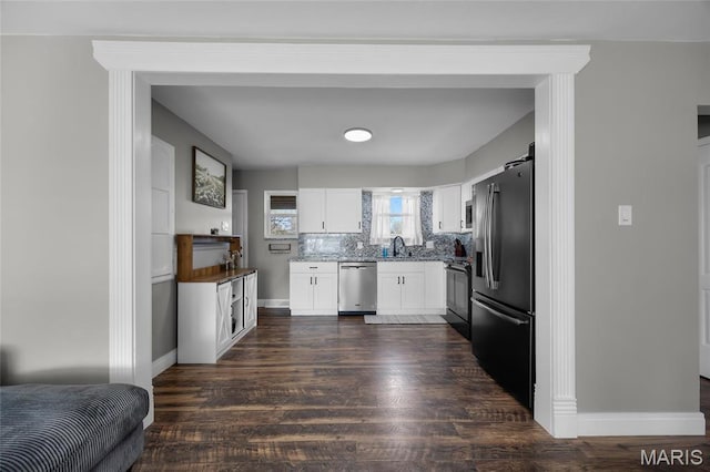 9748 Mackenzie Rd, Saint Louis, MO 63123 - kitchen featuring stainless steel appliances, a sink, dark wood-style floors, and white cabinetry
