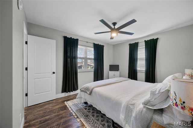 9748 Mackenzie Rd, Saint Louis, MO 63123 - bedroom with dark wood-style flooring, baseboards, and a ceiling fan