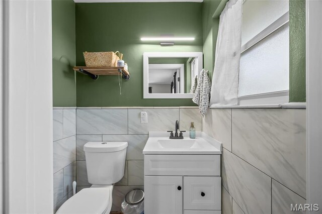 9748 Mackenzie Rd, Saint Louis, MO 63123 - half bathroom with tile walls, toilet, and vanity