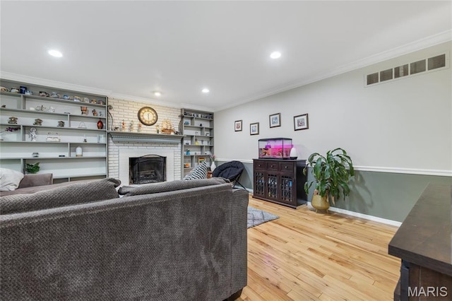 14964 Water Ridge Ct, Chesterfield, MO 63017 - living room featuring crown molding, light wood-type flooring, a brick fireplace, recessed lighting, and baseboards
