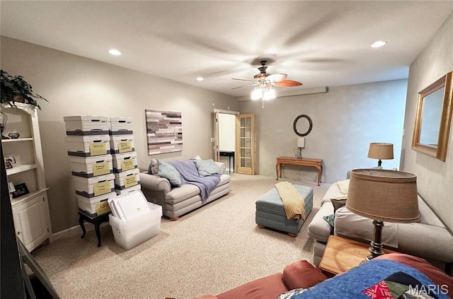 carpeted living area with ceiling fan and recessed lighting