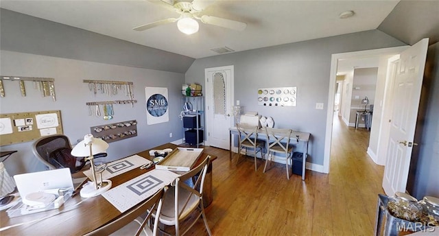 office space featuring ceiling fan, lofted ceiling, wood finished floors, and baseboards