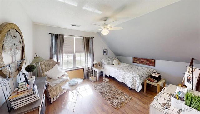 bedroom with lofted ceiling, wood finished floors, and a ceiling fan