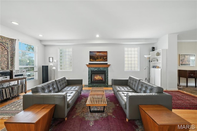 5784 Westminster Pl, Saint Louis, MO 63112 - living room featuring a premium fireplace, recessed lighting, and wood finished floors