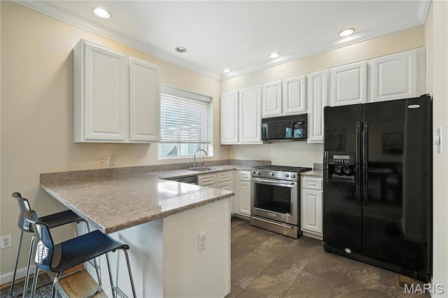 5784 Westminster Pl, Saint Louis, MO 63112 - kitchen with black appliances, ornamental molding, a peninsula, white cabinets, and recessed lighting