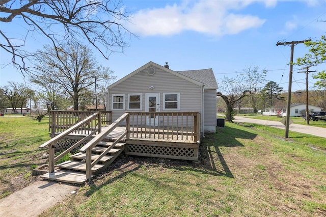view of front of home with a front yard and a deck