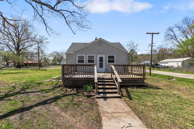 view of front of house with a front lawn and a wooden deck