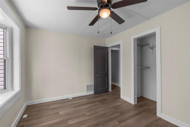 unfurnished bedroom with wood finished floors, a closet, and baseboards
