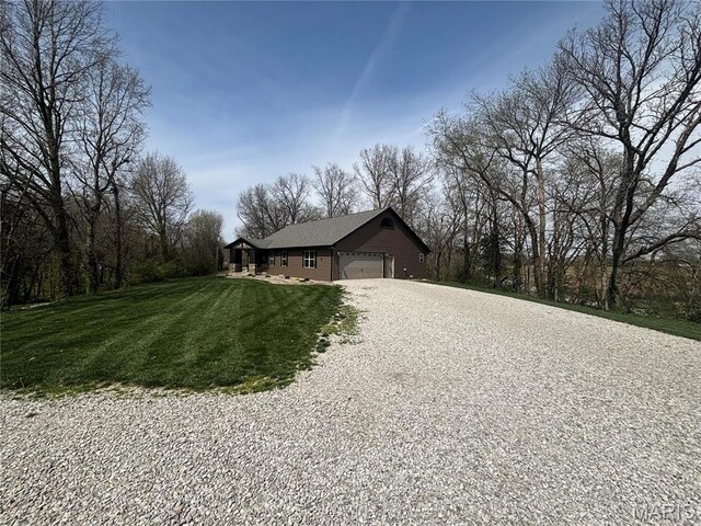5829 Marine Rd, Alhambra, IL 62201 - view of home's exterior featuring driveway, a yard, and an attached garage