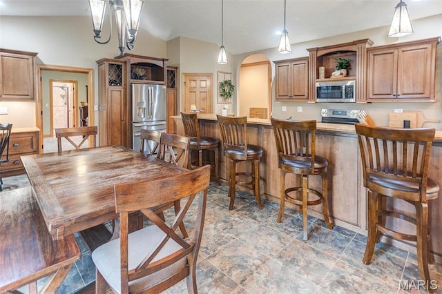 5829 Marine Rd, Alhambra, IL 62201 - kitchen featuring appliances with stainless steel finishes, open shelves, arched walkways, a kitchen bar, and brown cabinets