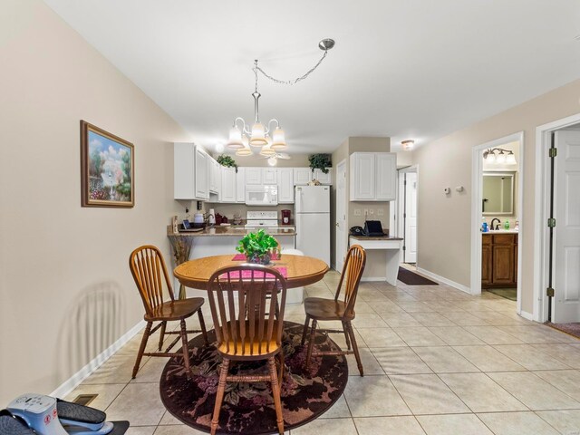 931 Georgetowne Dr, Ofallon, IL 62269 - dining space with a chandelier, light tile patterned floors, and baseboards