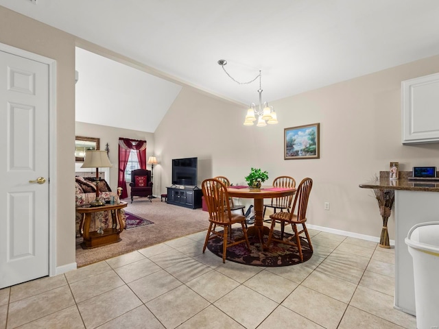 931 Georgetowne Dr, Ofallon, IL 62269 - dining room with light tile patterned floors, a chandelier, baseboards, light carpet, and lofted ceiling