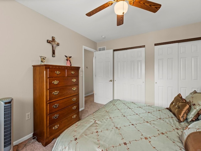 931 Georgetowne Dr, Ofallon, IL 62269 - bedroom featuring two closets, light colored carpet, baseboards, and ceiling fan