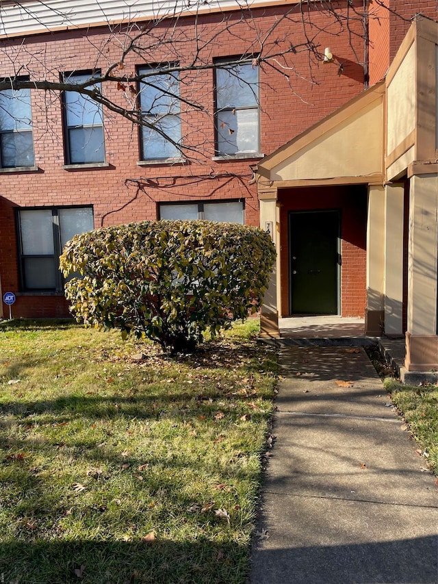 769 Walton Ave Unit 3, Saint Louis, MO 63108 - doorway to property with brick siding and a yard