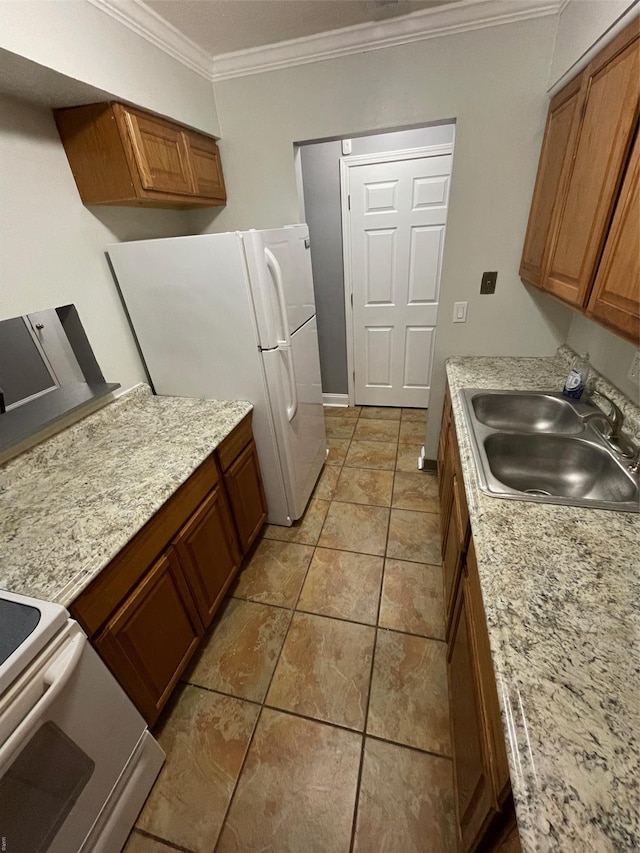 769 Walton Ave Unit 3, Saint Louis, MO 63108 - kitchen featuring a sink, freestanding refrigerator, crown molding, brown cabinets, and light countertops