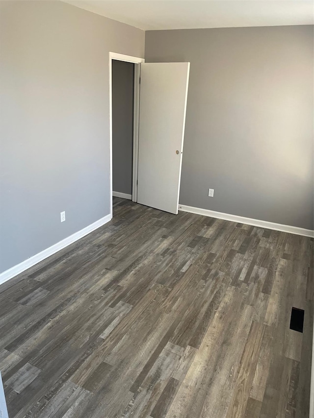 769 Walton Ave Unit 3, Saint Louis, MO 63108 - spare room featuring dark wood finished floors and baseboards